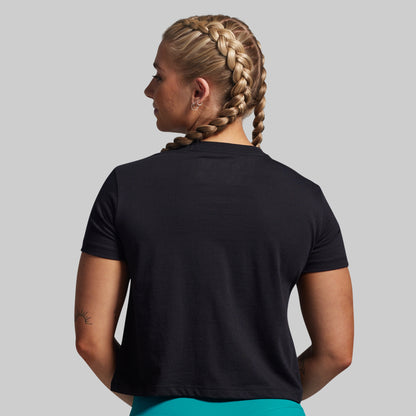 Person wearing a black t-shirt on a plain background