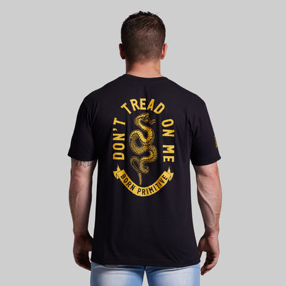 Man wearing a black t-shirt with 'Don't Tread on Me' graphic on the back against a gray background