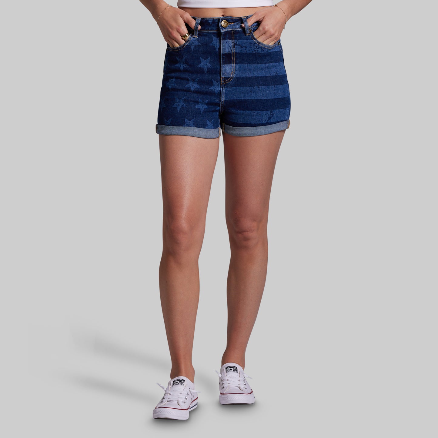 Person wearing blue denim shorts on a gray background