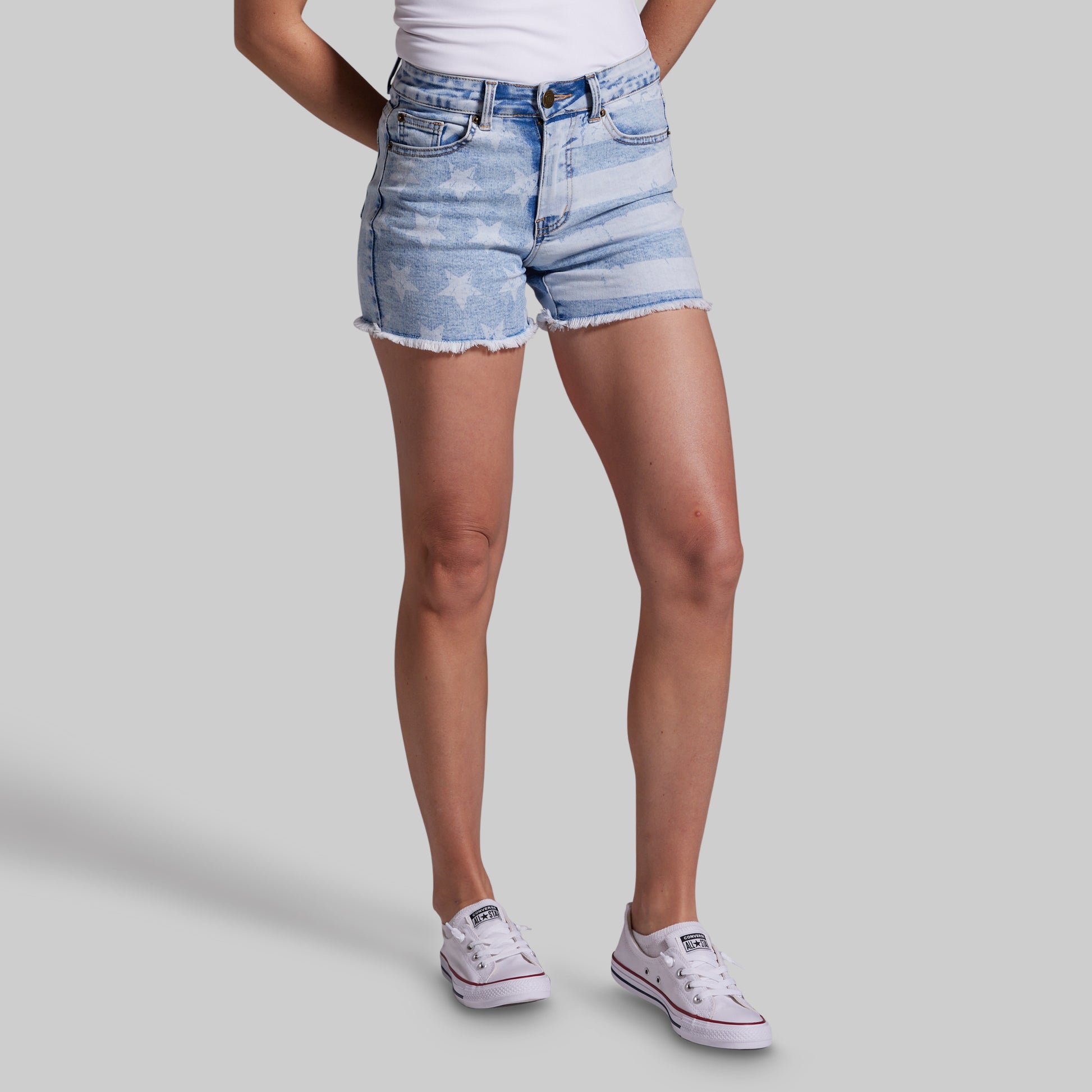 Person wearing light blue denim shorts on a gray background