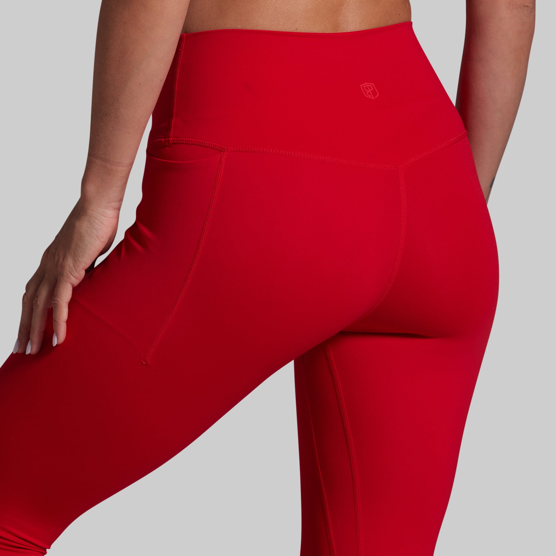 Red leggings with a brand logo on a gray background