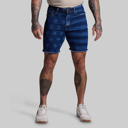 Person wearing blue denim shorts with star pattern on a gray background