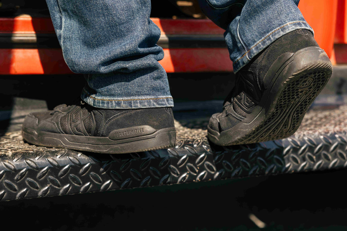 Black Urban Recon 1 standing on a truck running board 