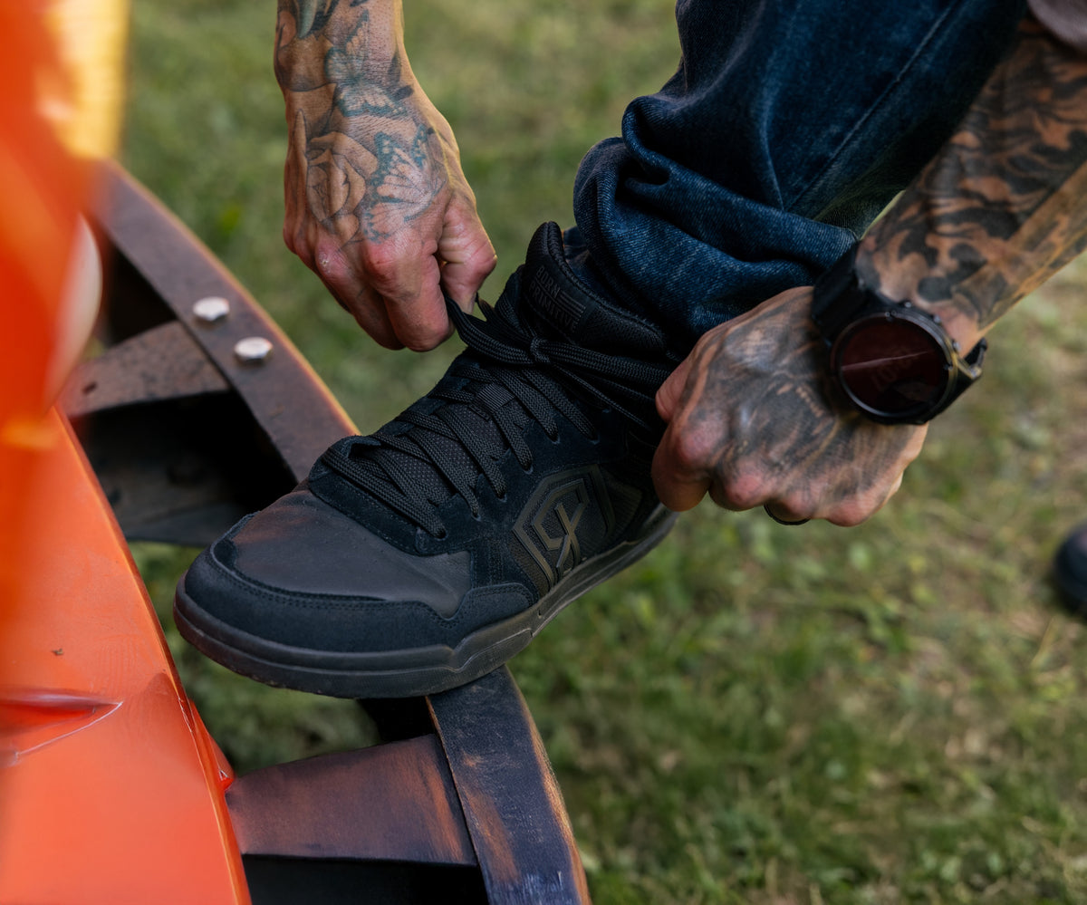 Black Urban Recon 1 shoe being tied 