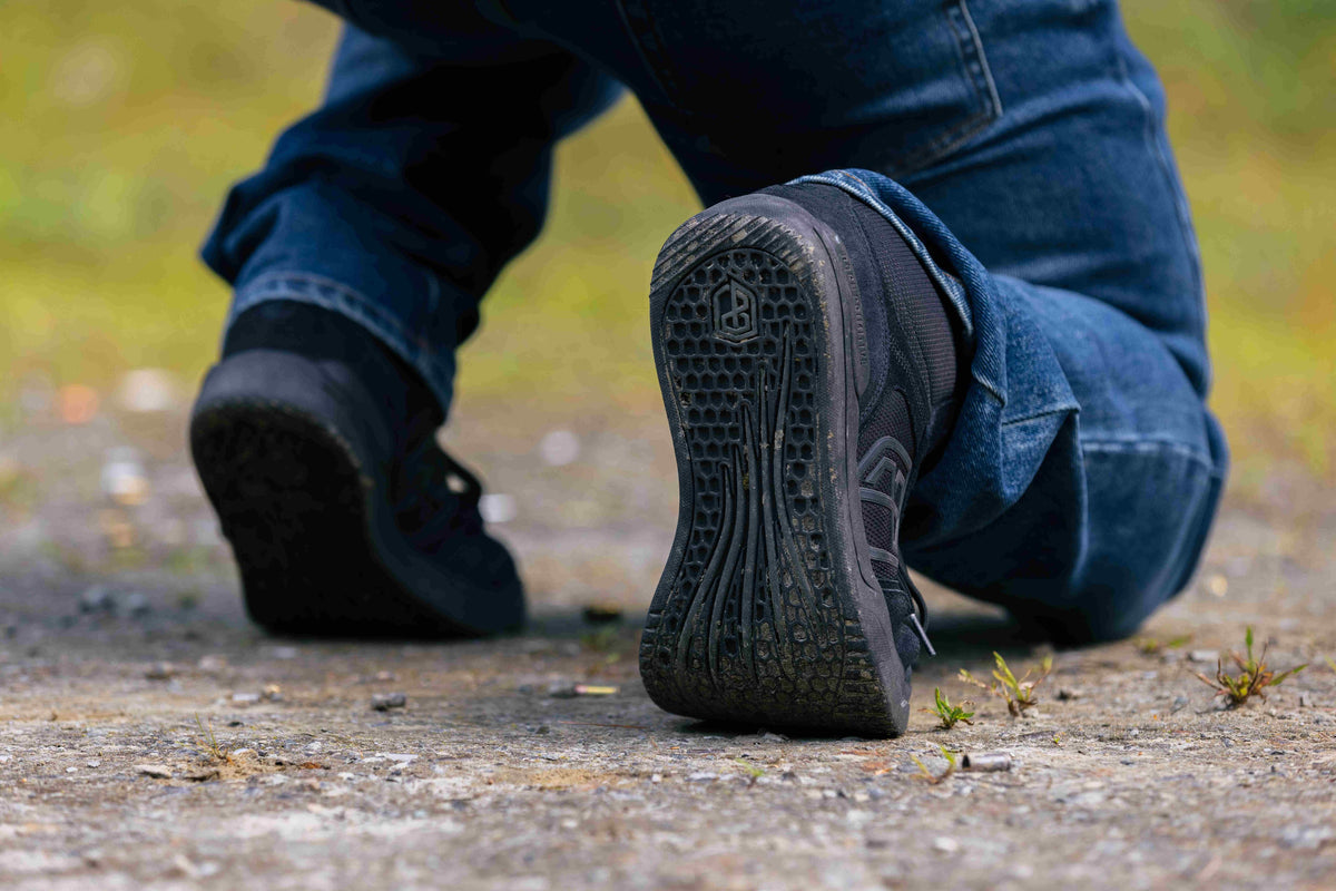 Black Urban Recon 1 kneeling while shooting, showing shoes sole