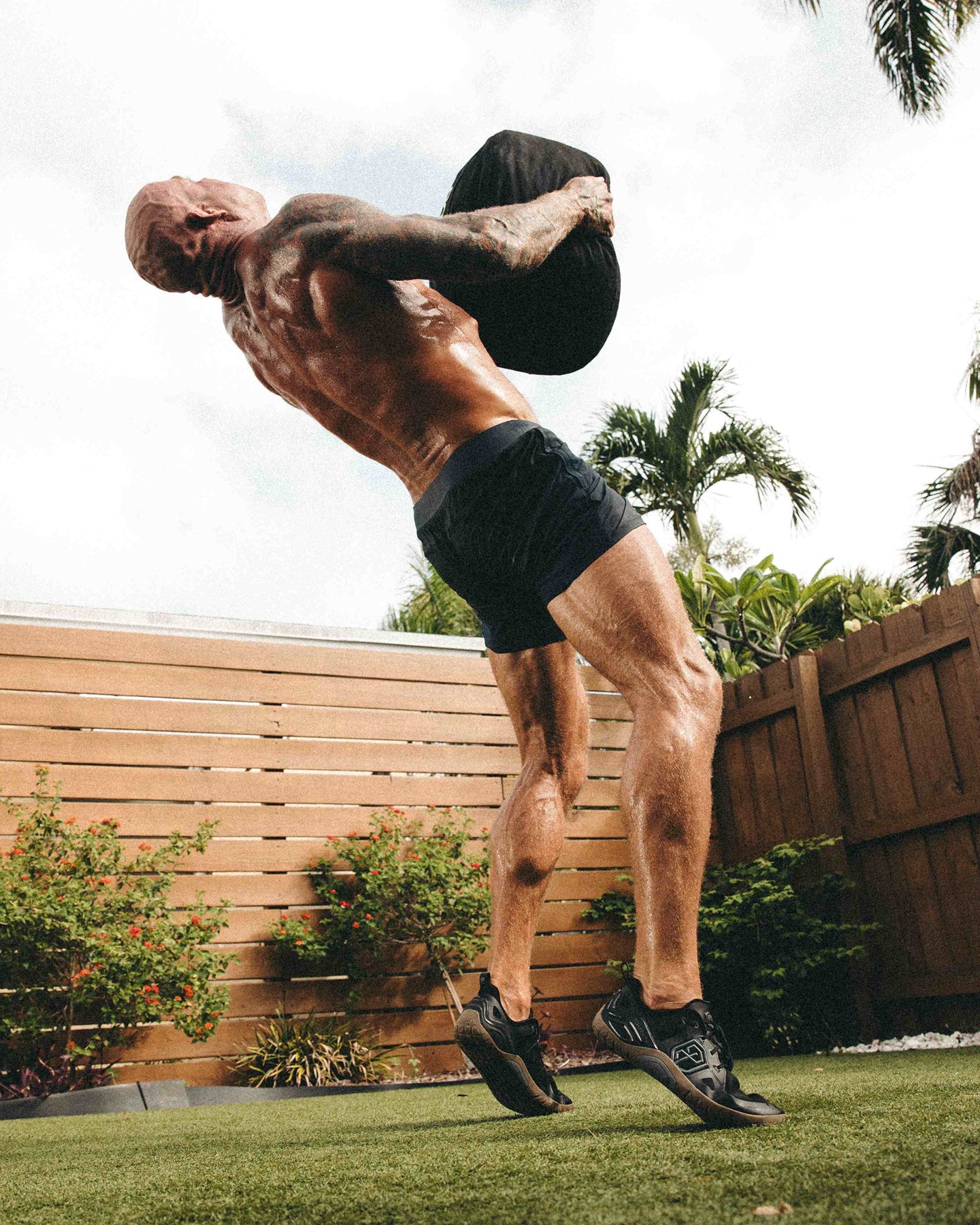 Barefoot athlete throwing medicine ball 
