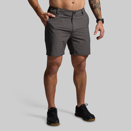 Person wearing gray shorts on a plain background
