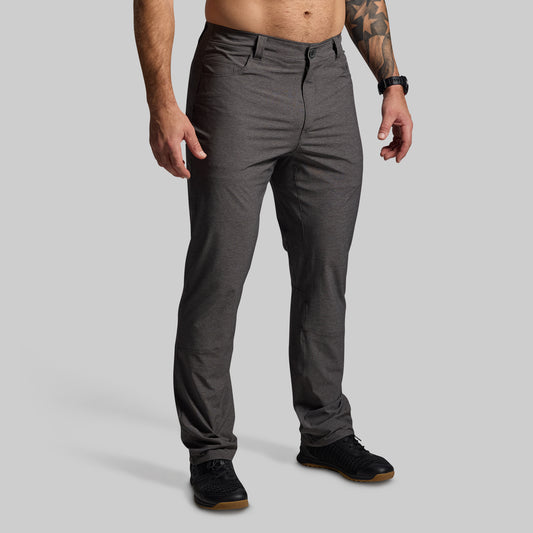 Person wearing gray pants on a plain background