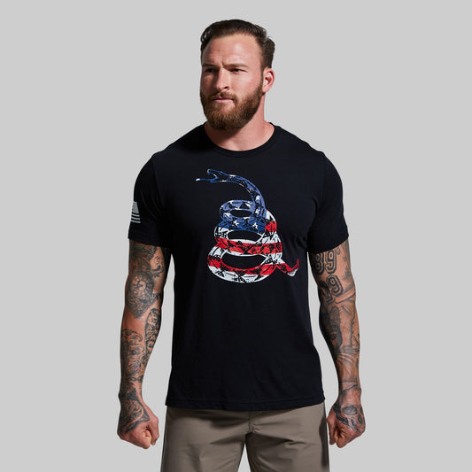 Man wearing a black t-shirt with a snake and flag design on a gray background