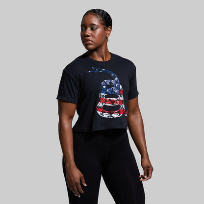 Person wearing a black t-shirt with a snake design on a gray background