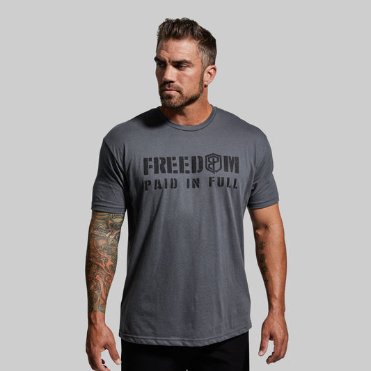 Man wearing a gray t-shirt with text on a plain background