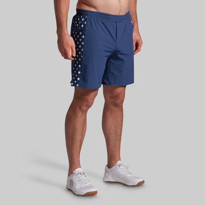 Person wearing blue athletic shorts with American flag design on a gray background