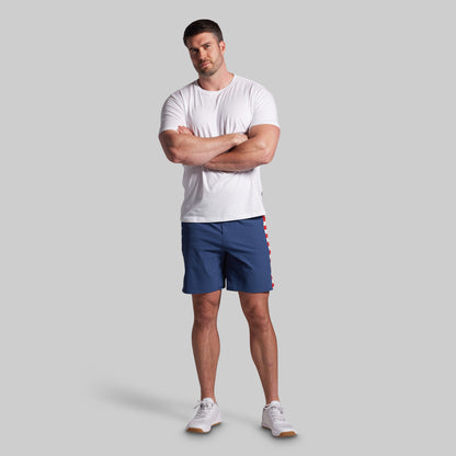 Man wearing a white t-shirt and blue shorts on a gray background