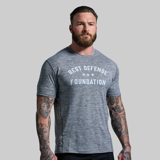 Man wearing gray t-shirt with "Best Defense Foundation" printed on the front.
