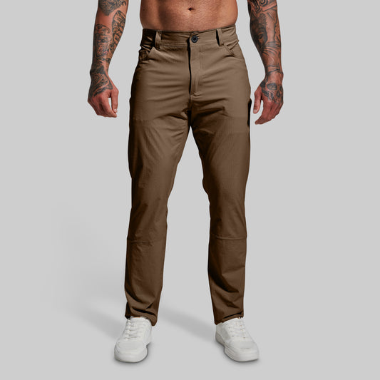 Brown pants worn by a person on a gray background