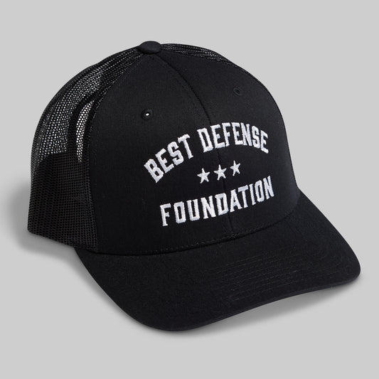 Black cap with 'Best Defense Foundation' text on a gray background