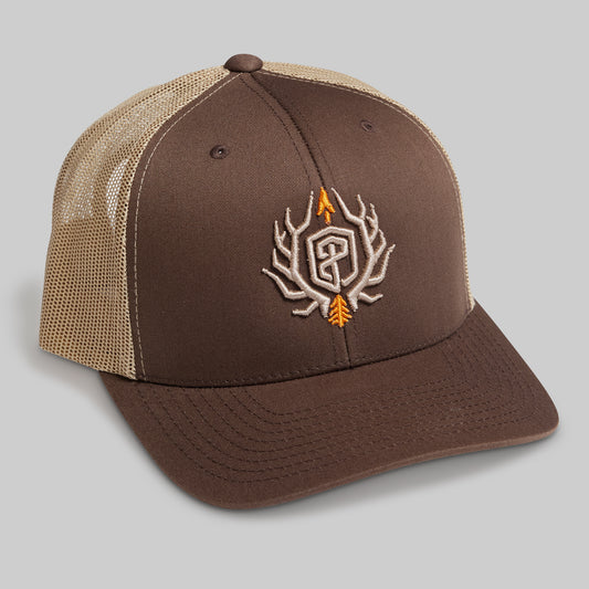 Brown and beige cap with embroidered design on a gray background