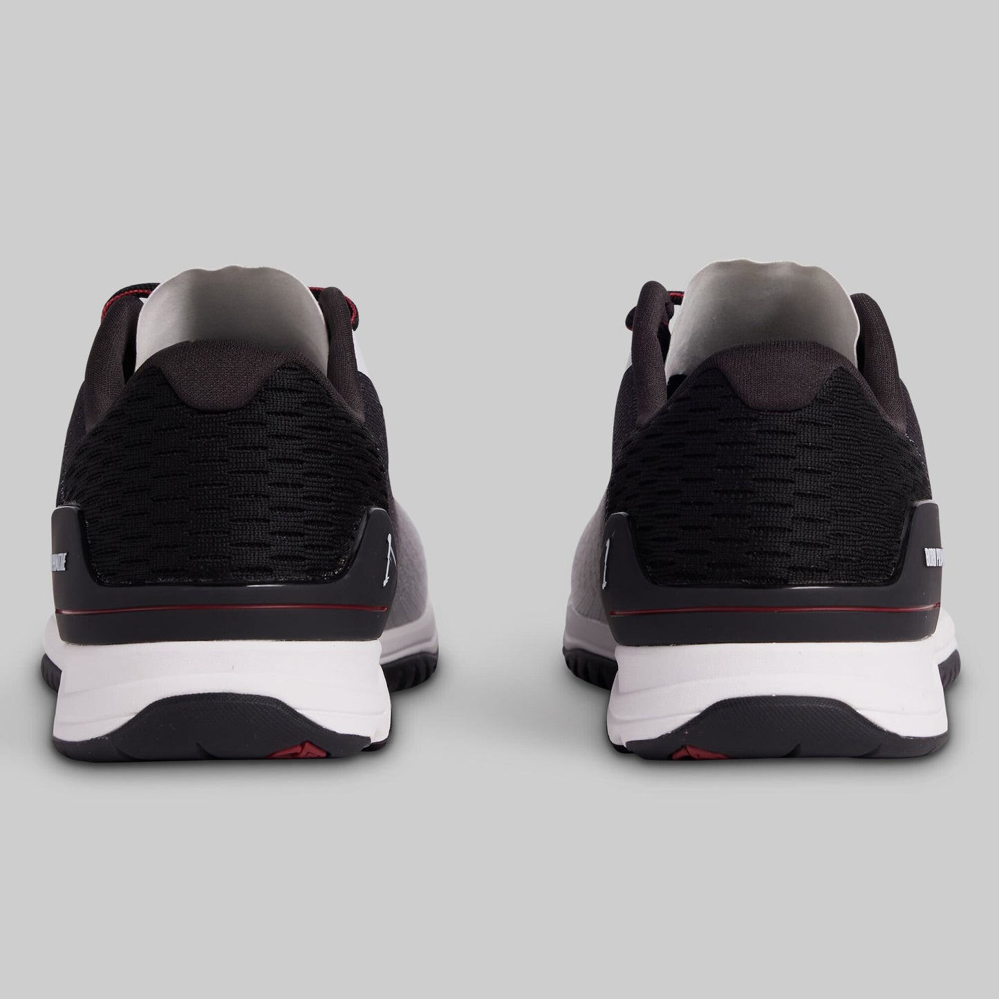 Black and white athletic shoes on a gray background