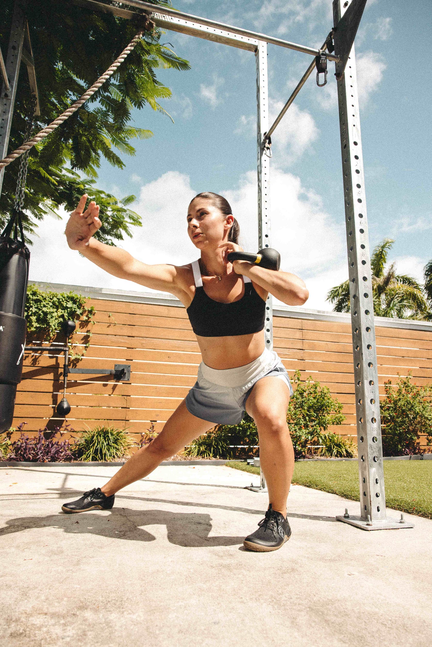 Barefoot athlete doing kettle bell lunge