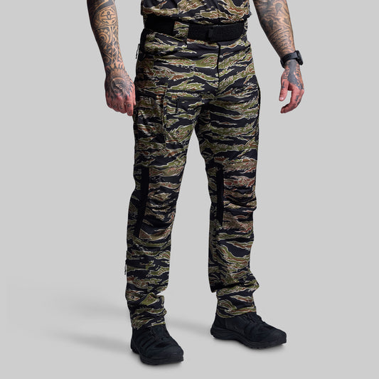 Person wearing camouflage pants on a gray background