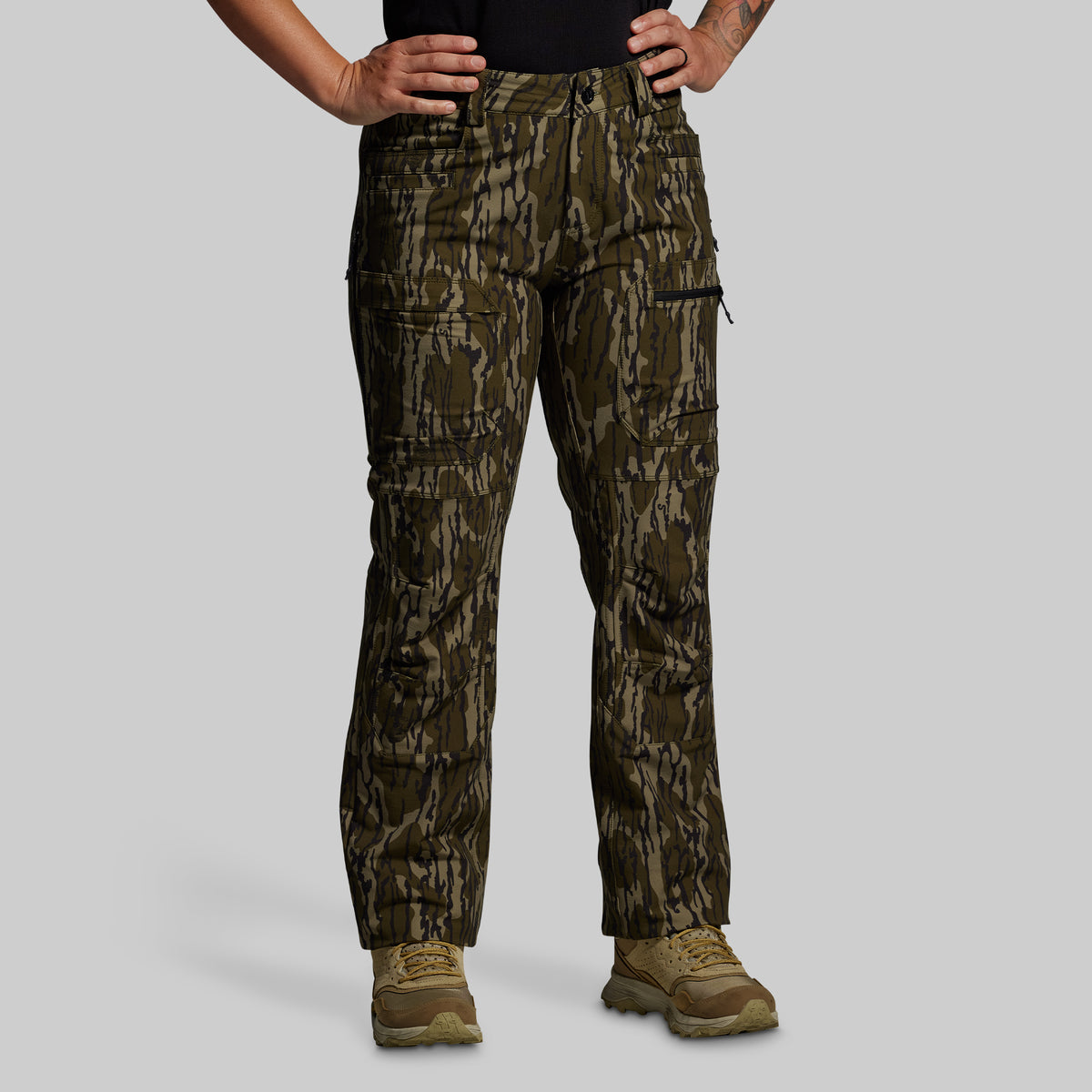 Camouflage pants worn by a person on a gray background