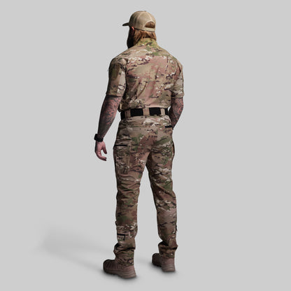 Person wearing a camouflage outfit on a gray background