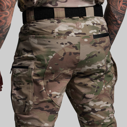 Camouflage pants with a visible brand logo on a gray background