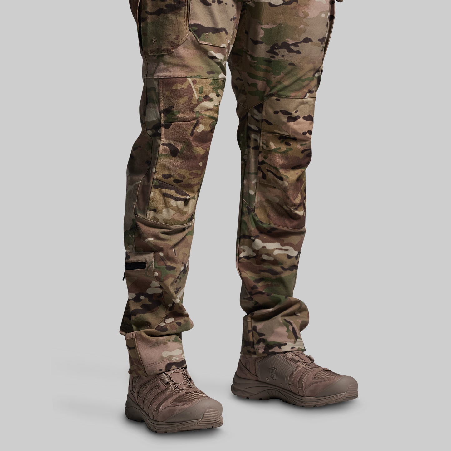 Camouflage pants and boots on a gray background