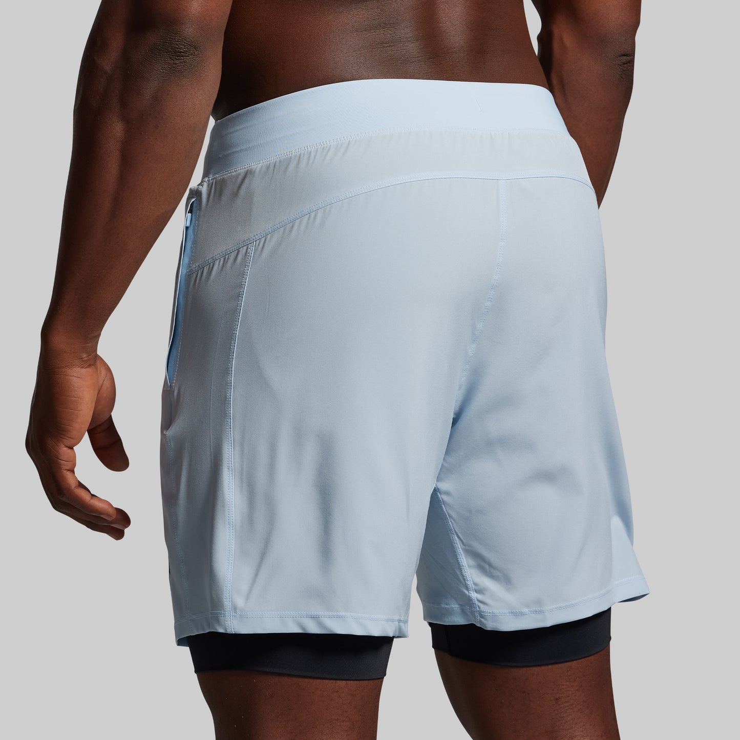 Light blue athletic shorts worn by a person on a neutral background