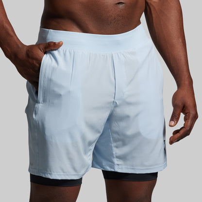 Light blue shorts worn by a person on a plain background