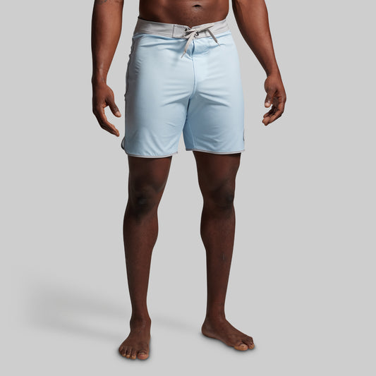 Light blue shorts worn by a person on a plain background