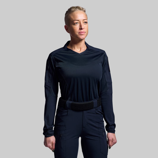 Person wearing a blue long-sleeve top and pants on a gray background