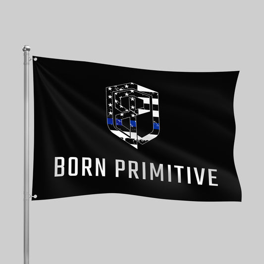 Black flag with 'Born Primitive' logo on a gray background