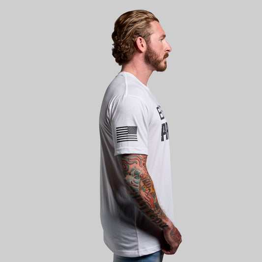 Side view of a man wearing a white t-shirt with a flag design on the sleeve.