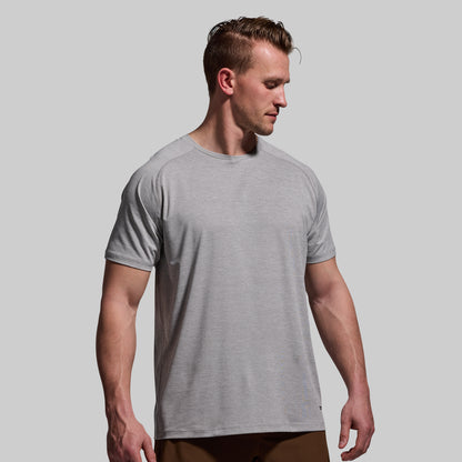 Man wearing a gray t-shirt against a plain background