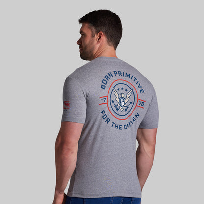 Man wearing a gray t-shirt with a logo and text on the back against a light gray background