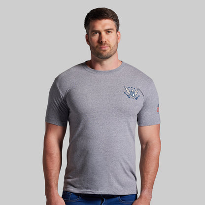 Man wearing a gray t-shirt with a logo on a plain background