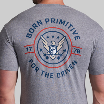 Gray t-shirt with 'Born Primitive' logo and text on the back