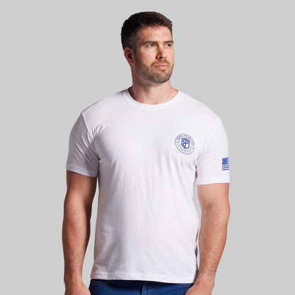 Man wearing a white t-shirt with a logo on a gray background