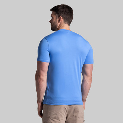 Man wearing a blue t-shirt on a gray background