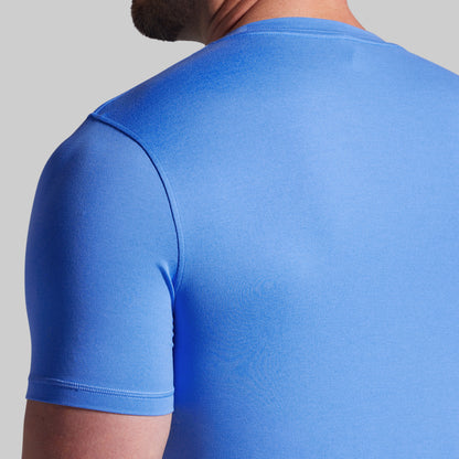 Blue t-shirt worn by a person on a gray background