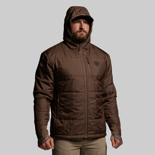 Man wearing a brown hooded jacket on a gray background