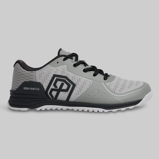 Gray athletic shoe with black accents on a light gray background