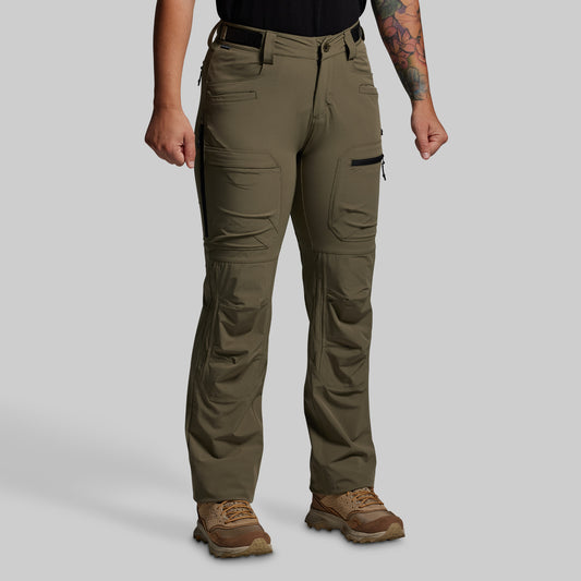 Person wearing olive green outdoor pants on a gray background