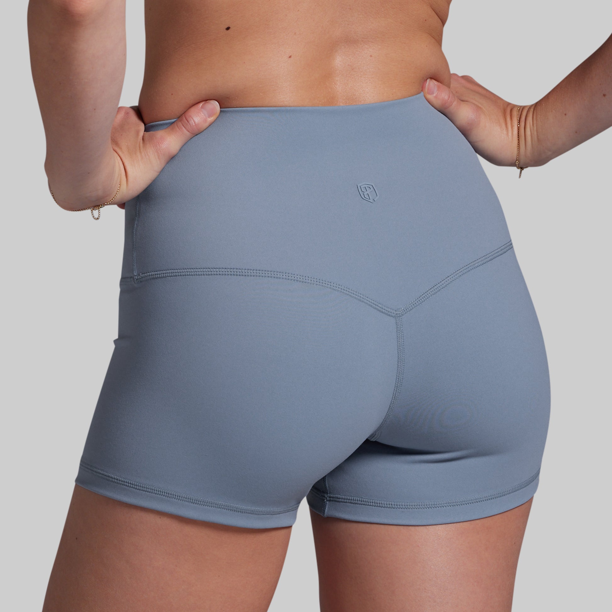 Gray athletic shorts worn by a person on a plain background