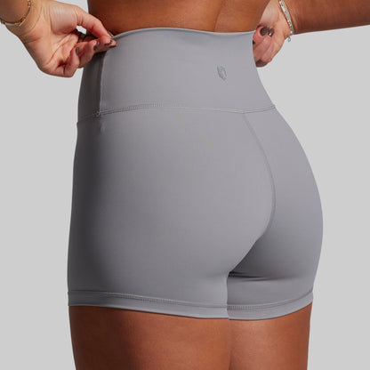 Person wearing gray athletic shorts on a plain background
