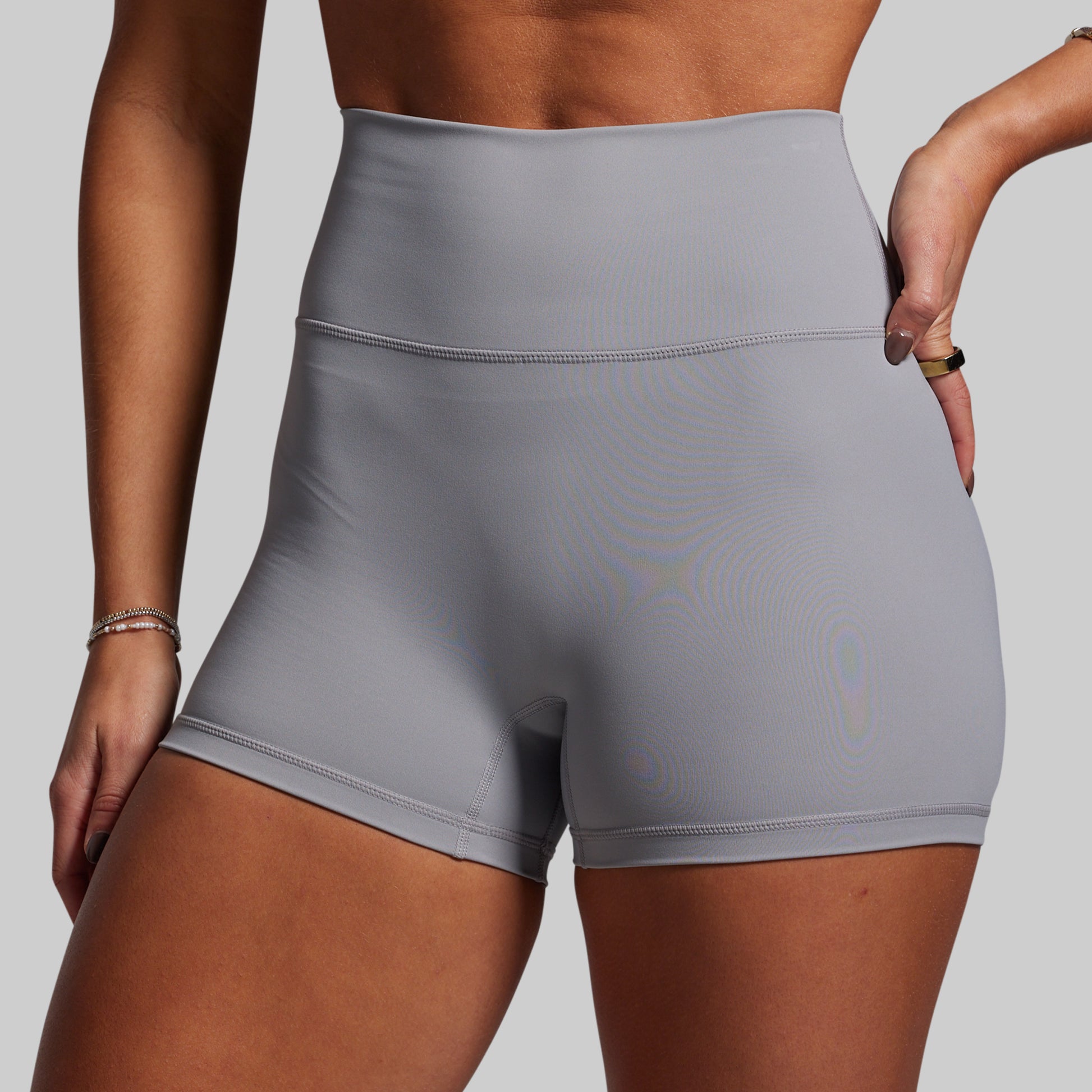 Gray athletic shorts worn by a person on a plain background