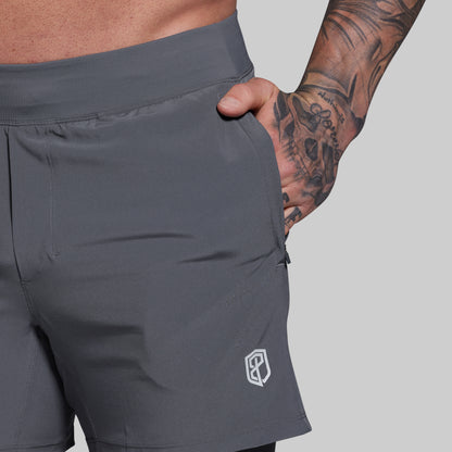 Gray shorts with a brand logo on a gray background
