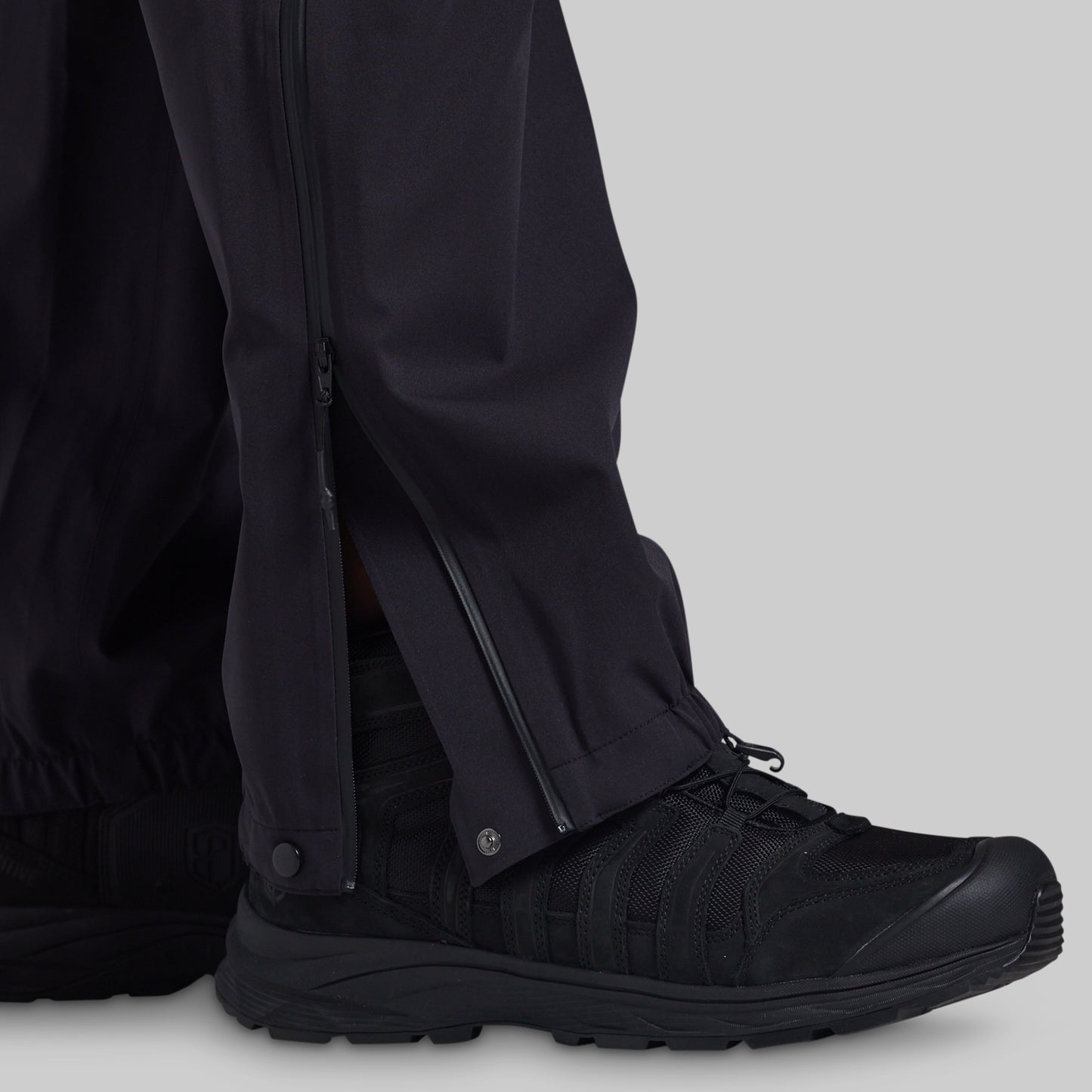 Full-length side zipper open over a boot on black Mission FLEX Rain Pant 2.0