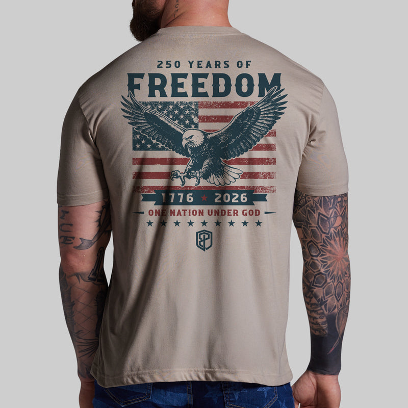 T-shirt with eagle design and text on the back, worn by a person with tattoos.